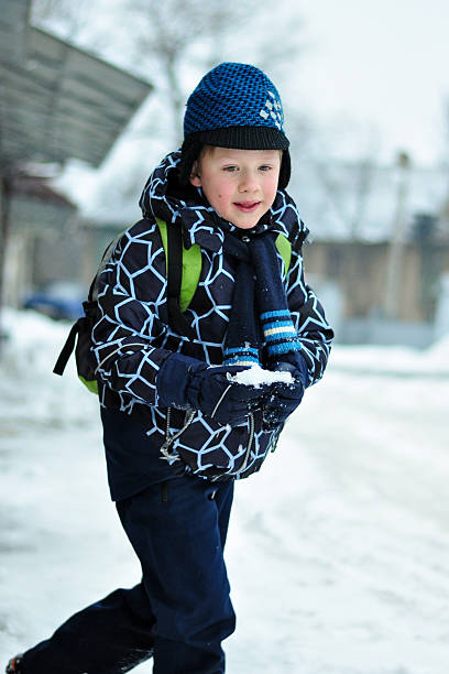 istock boy in winter with snow in hands 533862152