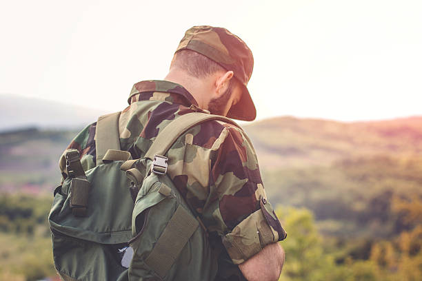 istock Young military man scouting around in forest 533863336