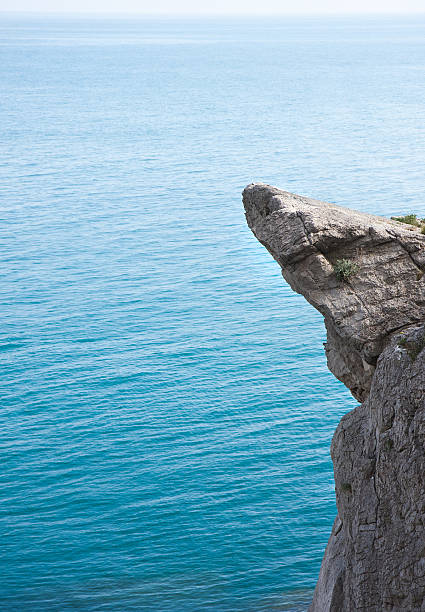 istock High mountain cliff at the calm sea background 533869159