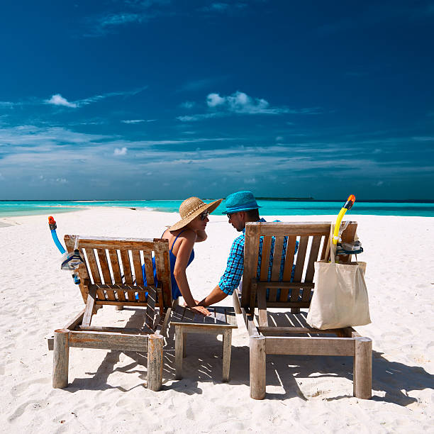 istock Couple relax on a beach at Maldives 533874209