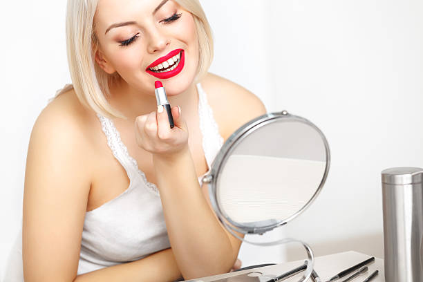 istock Red lips. Beautiful Woman Doing Daily Makeup. Lipstick applying 533875005