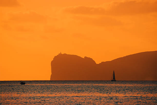 istock orange sunset over Capo Caccia 533887259