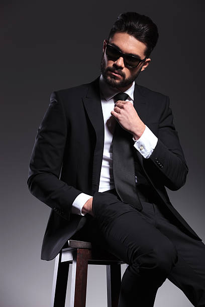 istock Handsome young elegant business man sitting on a stool 533888561
