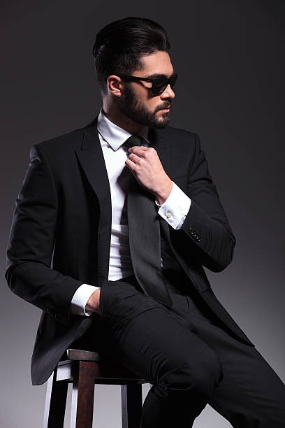 istock elegant business man fixing his tie 533888563
