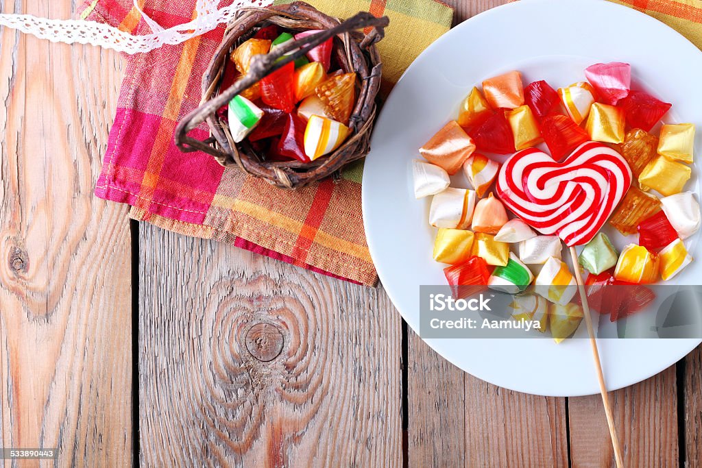 Plate and basket with colorful sweet candies Plate and basket with colorful sweet candies. Copy space background. Selective focus. Traditional Seker Bayram holidays candies 2015 Stock Photo