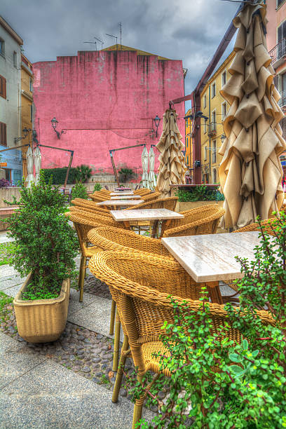istock tables and chairs in a small italian square 533890449