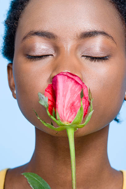 女性のバラの香り - vertical single flower women teenager ストックフォトと画像