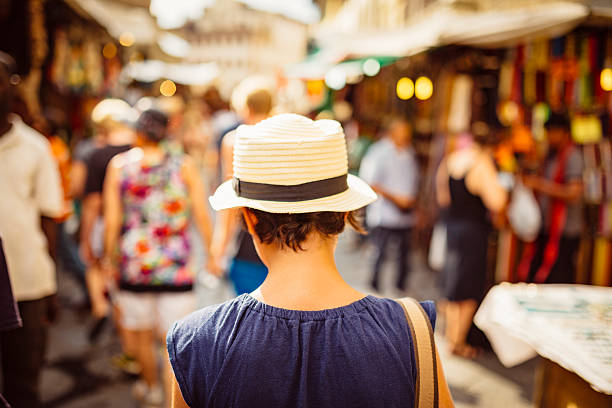 istock girl with hat walking in florence streets 533893282