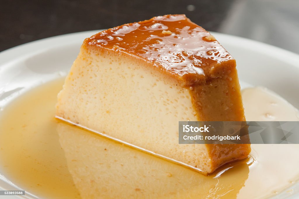 Slice of Milk Pudding Slice of Milk Pudding over a wooden table Dessert - Sweet Food Stock Photo