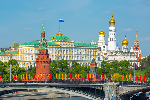 View of Moscow Kremlin behind the Bolshoy Kamenny Bridge with bright flags