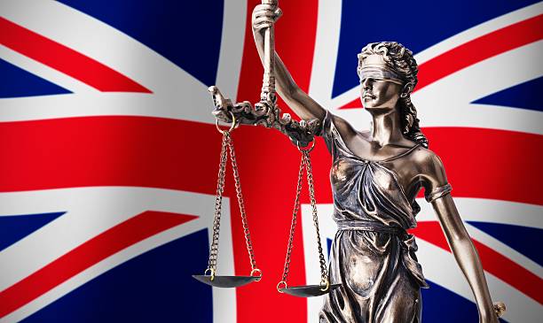 istock Themis with scale, symbol of justice on UK flag background 533896852
