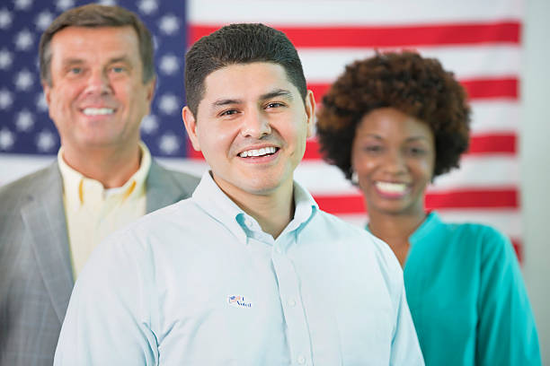 istock Smiling man stands in front of american flag 533899720