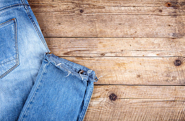 istock Neatly folded jeans on wooden background 533902070