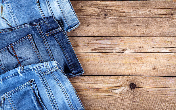 istock Neatly folded jeans on wooden background 533902148