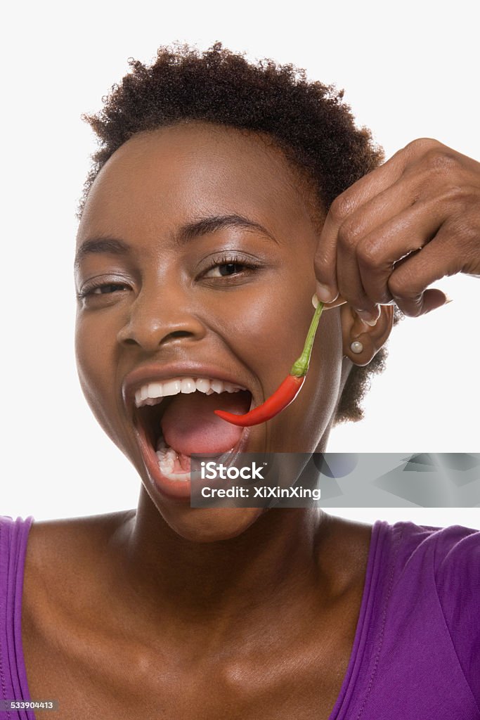 Woman eating chili pepper Chili Pepper Stock Photo