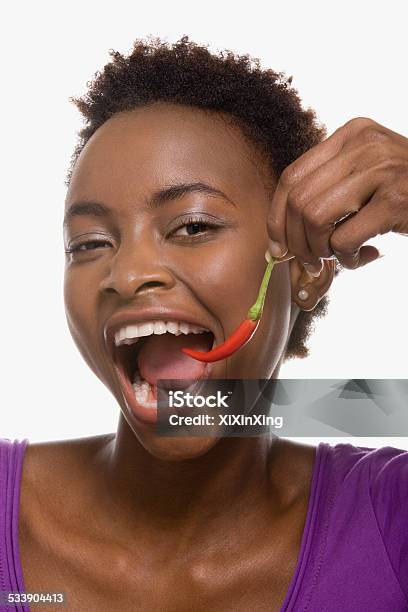 Woman Eating Chili Pepper Stock Photo - Download Image Now - Chili Pepper, One Woman Only, Women