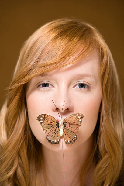 istock Butterfly covering womans mouth 533904453