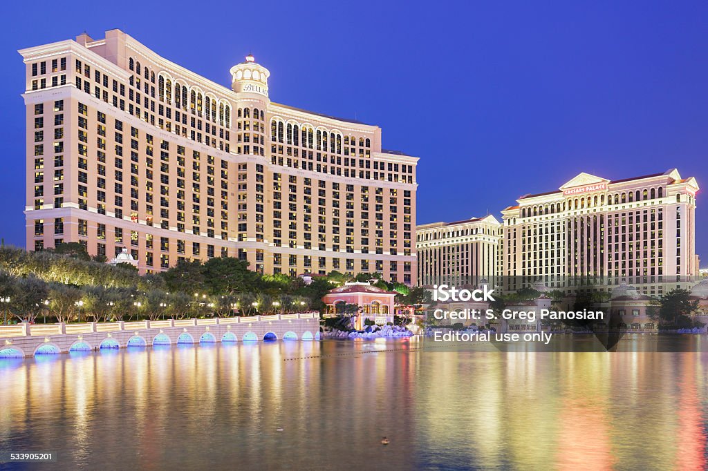 Bellagio and Caesars Palace - Las Vegas Las Vegas, USA - December 5, 2014: Skyscraper towers of Bellagio and Caesars Palace hotels reflected in the man made lake Bellagio. The luxury resort hotels are located on the Las Vegas strip. 2015 Stock Photo