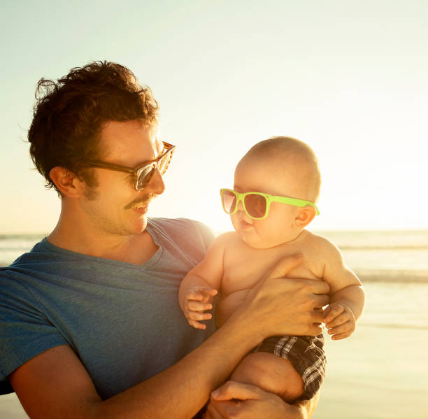 istock Father and son on the beach wearing sunglasses 533905587