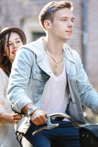 istock Young couple with bicycle through the city streets 533907105