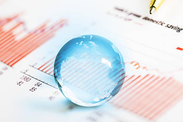 istock pen on histogram graph with crystal global ball 533907502