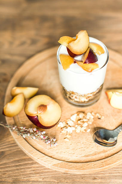 istock healthy breakfast: granola, cereal, yogurt with peach and plum 533908430