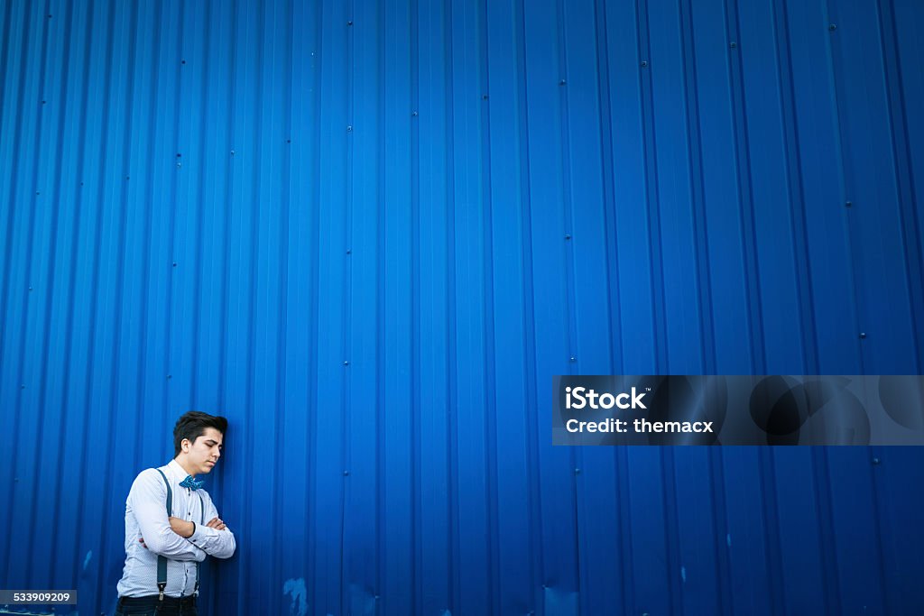 Young man standing with blue background Young man standing with blue background. 20-29 Years Stock Photo