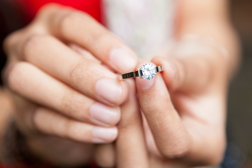 Woman holding wedding / engagement diamond ring