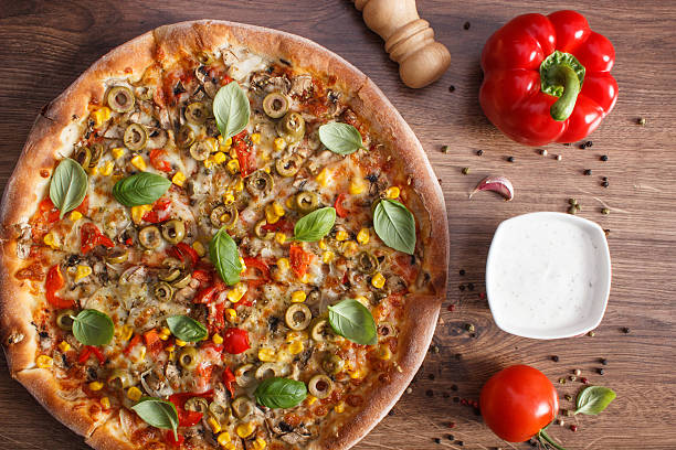 istock Vegetarian pizza and ingredients with spices on rustic wooden background 533909746