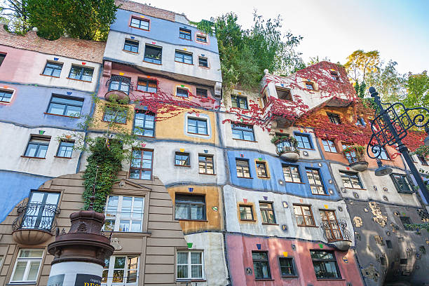 Colorful facade of the famous Hundertwasserhaus in Vienna, Austria Colorful facade of the famous Hundertwasserhaus in Vienna, Austria, an apartment house built after the idea and concept of Friedensreich Hundertwasser and architect Joseph Krawina. hundertwasser haus in vienna austria stock pictures, royalty-free photos & images