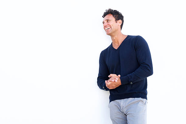 Middle aged man laughing against isolated white background