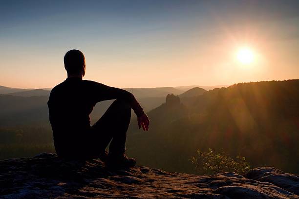 istock Hiker take relaxing  enjoying sunset at horizon. Vivid effect. 533915732