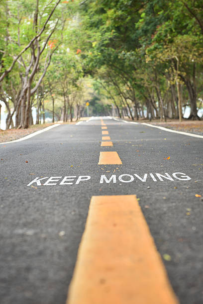 istock Words of keep moving with yellow line marking on road 533923774