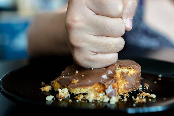 istock fist crushing chocolate donut cake 533924330
