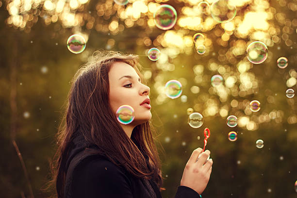 istock Young girl blowing soap bubbles. 533925248