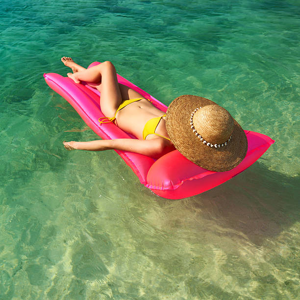 istock Woman relaxing on inflatable mattress 533933251