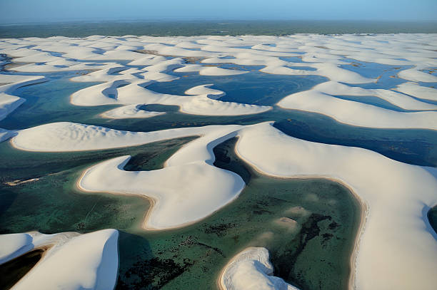 Aerial view of Lencois Maranhenses National Park, Brazil Aerial view of Lencois Maranhenses National Park, located in northeastern Brazil, low, flat, occasionally flooded land, overlaid with large, discrete sand dunes with blue and green lagoons brazil desert maranhao state national park stock pictures, royalty-free photos & images