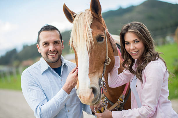 istock Happy couple with a horse 533938875