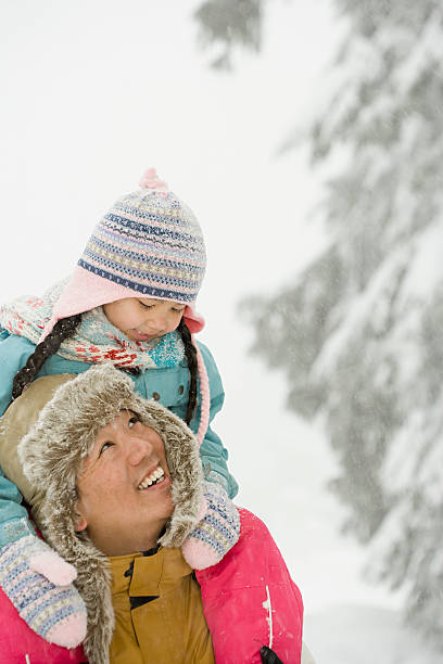 Father and daughter in snow
