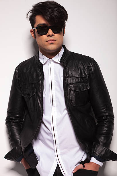 istock fashion man posing against a white wall 533939699