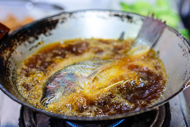 istock fish in a frying pan with hot oil 533956183