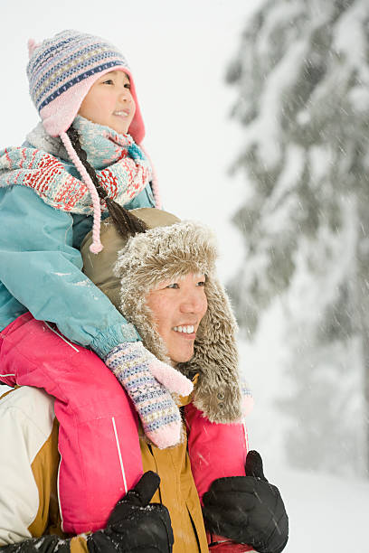 istock Father and daughter in snow 533956555