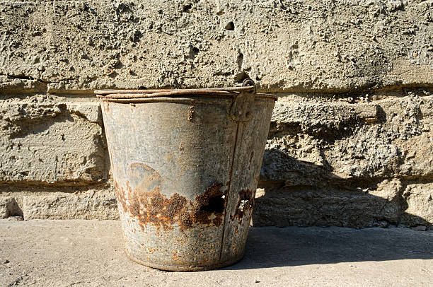 istock old bucket on background of a cement wall 533958813