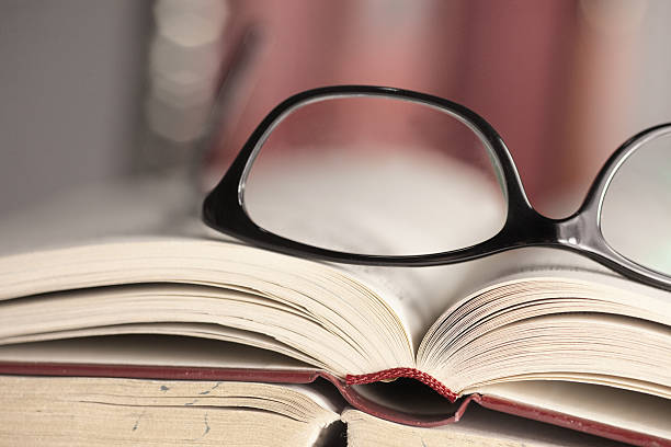 istock Glasses are laying on a book 533959177