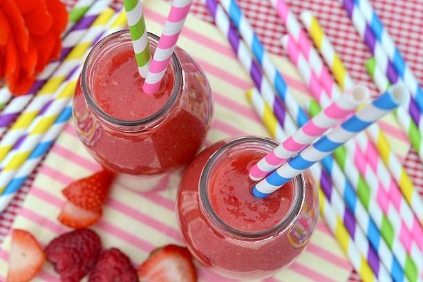 istock Strawberry Smoothie with striped straws 533959443