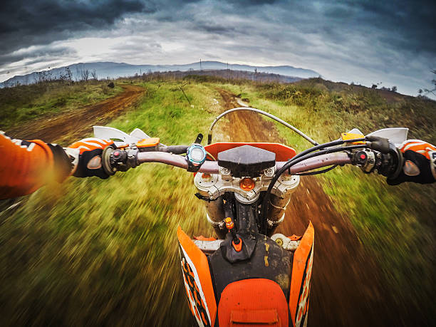 Enduro Motocross motorbike racing offroad Riding a motocross dirtbike offroad: point of view camera filming.  throttle photos stock pictures, royalty-free photos & images