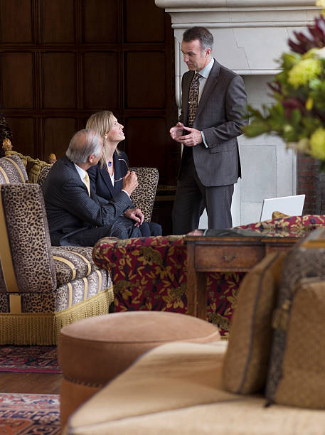 istock Three Businesspeople Talking In Office Lobby 533961301