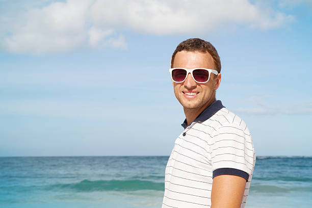 istock Man standing with white sunglasses on summer sea coast 533963281