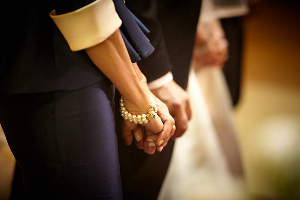 istock Godparents holding hands in the wedding ceremony 533965319