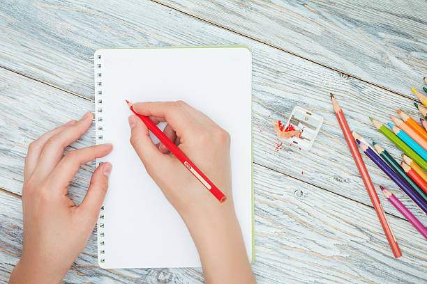 istock hand holds the colored pencil 533974378
